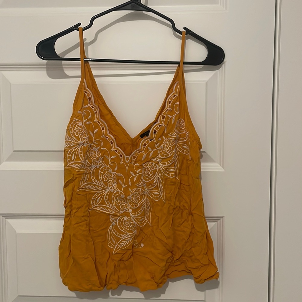 White embroidered flowers on a yellow tank. Tags on still.